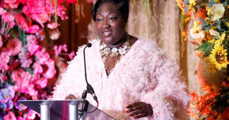 A photo of Phyll Opoku-Gyimah wearing a pink dress as she speaks at the Kaleidoscope Trust Gala dinner