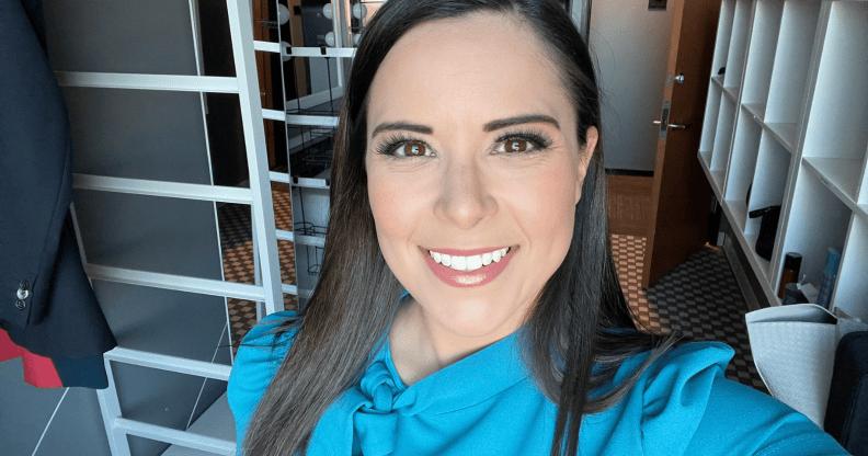 A Twitter screenshot of TV anchor Ashley Michels wearing a light blue top and smiling as she takes a selfie in the green room of KWGN news set.