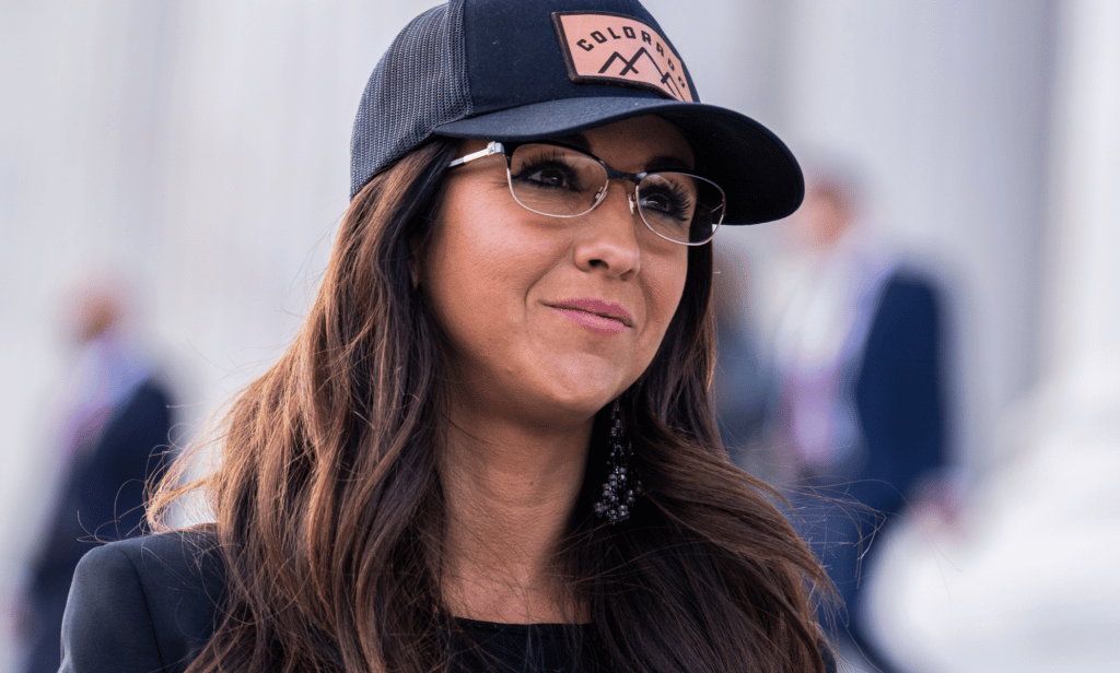 Lauren Boebert wears a black baseball cap with the word 'Colorado' on it