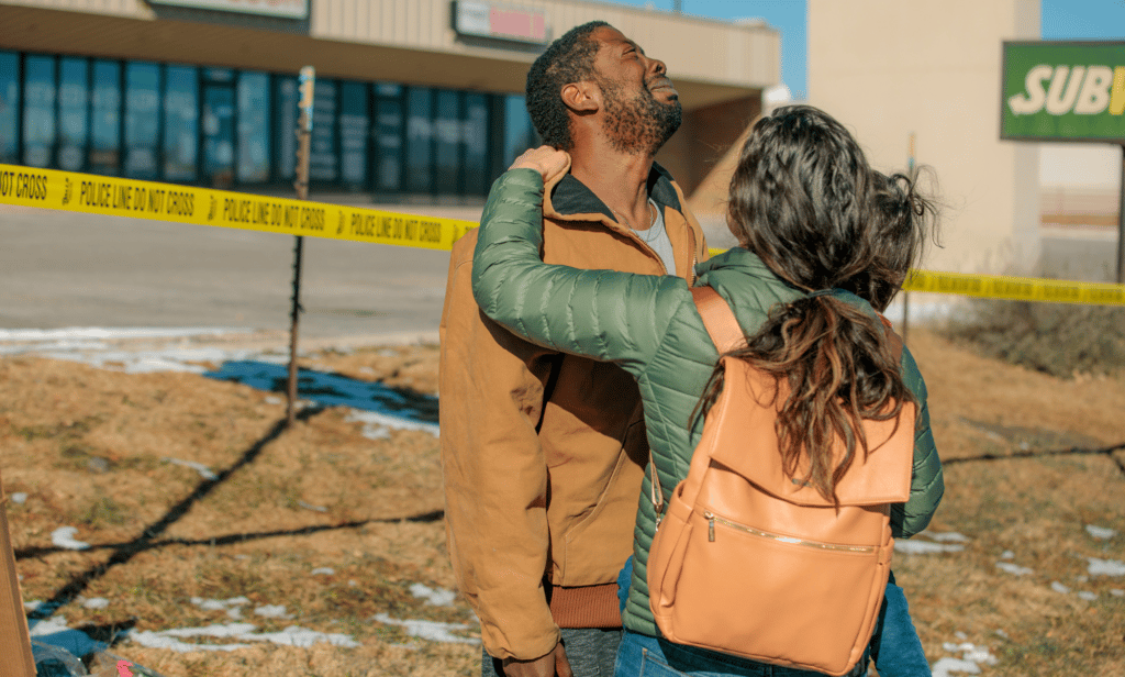 Joshua Thurman, a witness to the deadly Colorado Springs shooting, is comforted by a friend outside Club Q