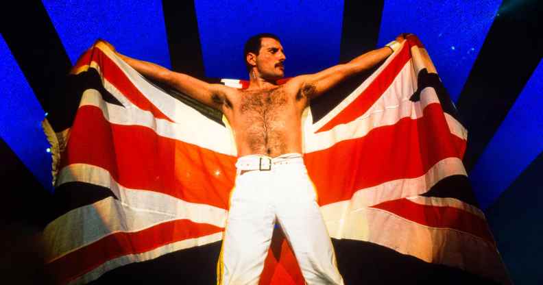 Freddie Mercury holding up a Union Jack on stage.