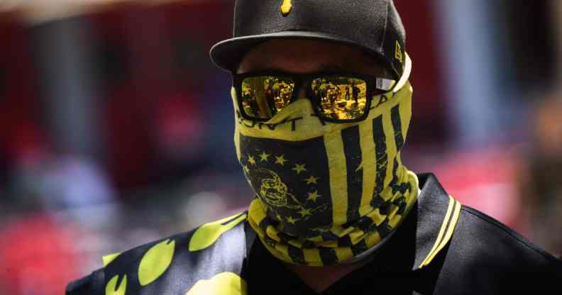 One of the members from the far-right group Proud Boys wearing a black and yellow bandana, cap and sunglasses