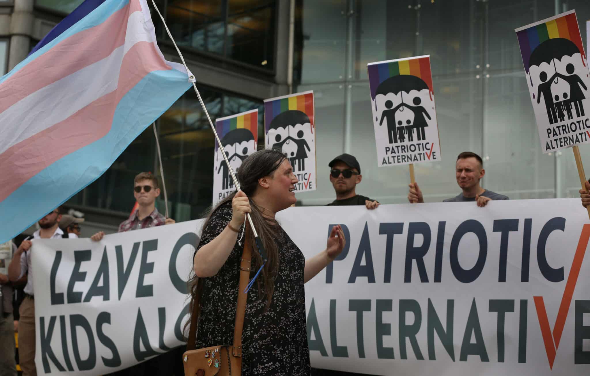 A protester carrying a Transgender pride flag confronts Patriotic Alternative supporters who oppose the drag queen story hour outside the Forum library. 