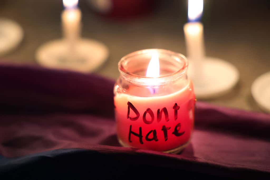 A candle with a message burns at a makeshift memorial near the Club Q nightclub on November 20, 2022.