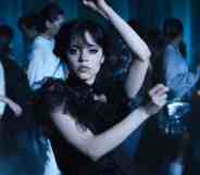 A still from Netflix's Wednesday series showing actor Jenna Ortega as Wednesday Addams dressed in a black dress and holding a dance pose