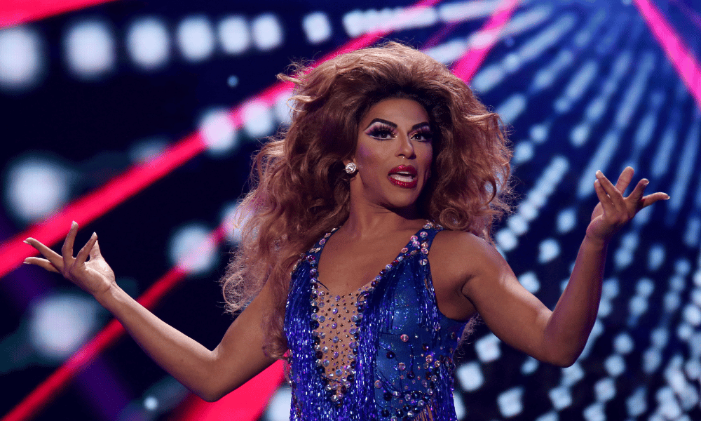 Drag queen Shangela performing in a blue leotard