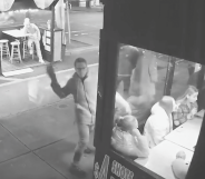 CCTV footage of man throwing a brick at window