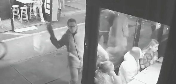 CCTV footage of man throwing a brick at window