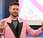 PinkNews' Chief Operating Officer Anthony James wears a pink blazer with black lapels as he speaks at the PPA Independent Publisher Conference and Awards on 25 November 2022 (PPA)