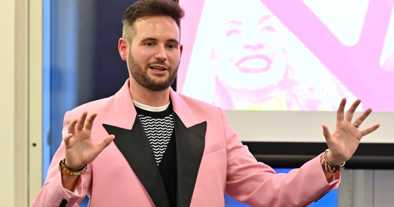 PinkNews' Chief Operating Officer Anthony James wears a pink blazer with black lapels as he speaks at the PPA Independent Publisher Conference and Awards on 25 November 2022 (PPA)