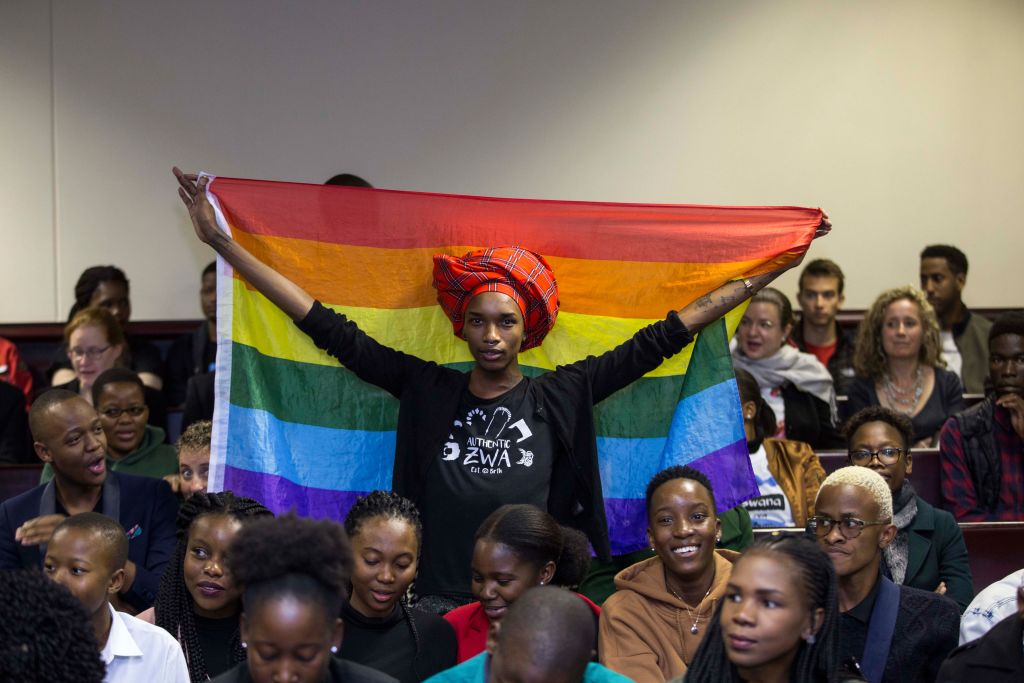 An activist holds up a rainbow flag to celebrate inside Botswana High Court after it ruled to decriminalise homosexuality. 