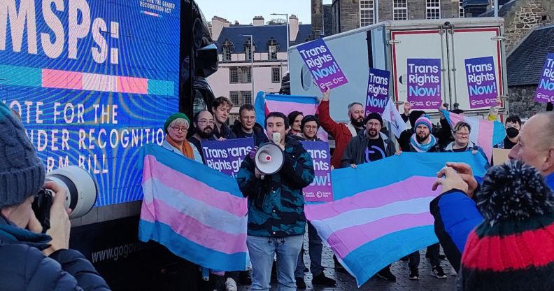 A group of people holding up the trans flags and signs in support of the trans community call on MSPs to pass the Gender Recognition Reform (Scotland) bill