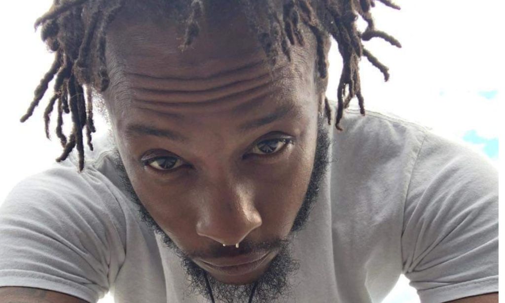 A selfie photo of Mar'Quis Jackson wearing a white t-shirt shows him staring into the camera