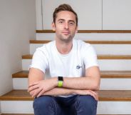 Author Daniel harding wearing white t-shirt, blue jeans, looking at camera with his arms crossed