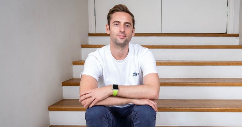 Author Daniel harding wearing white t-shirt, blue jeans, looking at camera with his arms crossed