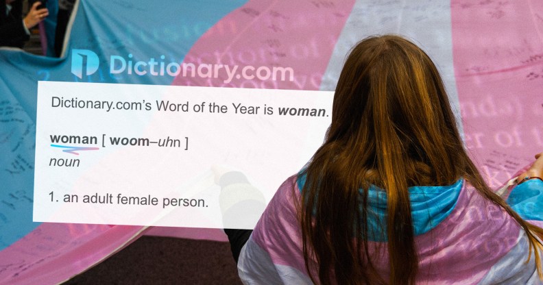 A woman stands with her back to the camera, wearing a trans flag while the dictionary definiton of the word woman is next to her.