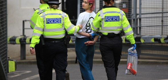 Phoebe Plummer is led away by police officers