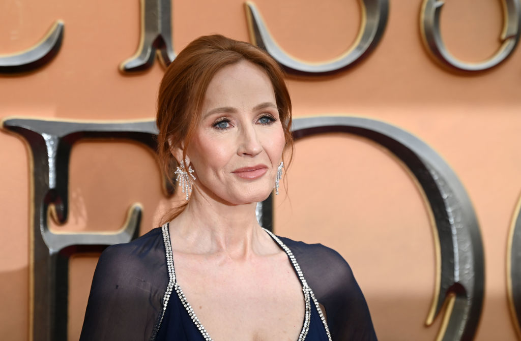 A photo of author JK Rowling wearing a low cut black dress as she poses for photos at the world premiere of Fantastic Beasts: The Secrets of Dumbledore