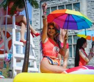 A photo of A drag queen holding an umbrella with Pride rainbow colours on a float at Nashville Pride parade