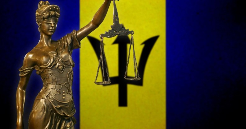 Lady Justice in front of the Barbados flag