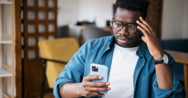 Stock image of a person using their phone