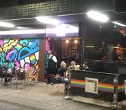 A photo of Sheffield gay club Queer Junction shows a group of people sat outside at one of its tables