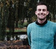 Photo of Christian teacher Joshua Sutcliffe wearing a turquoise top smiling as he stands in a countryside setting