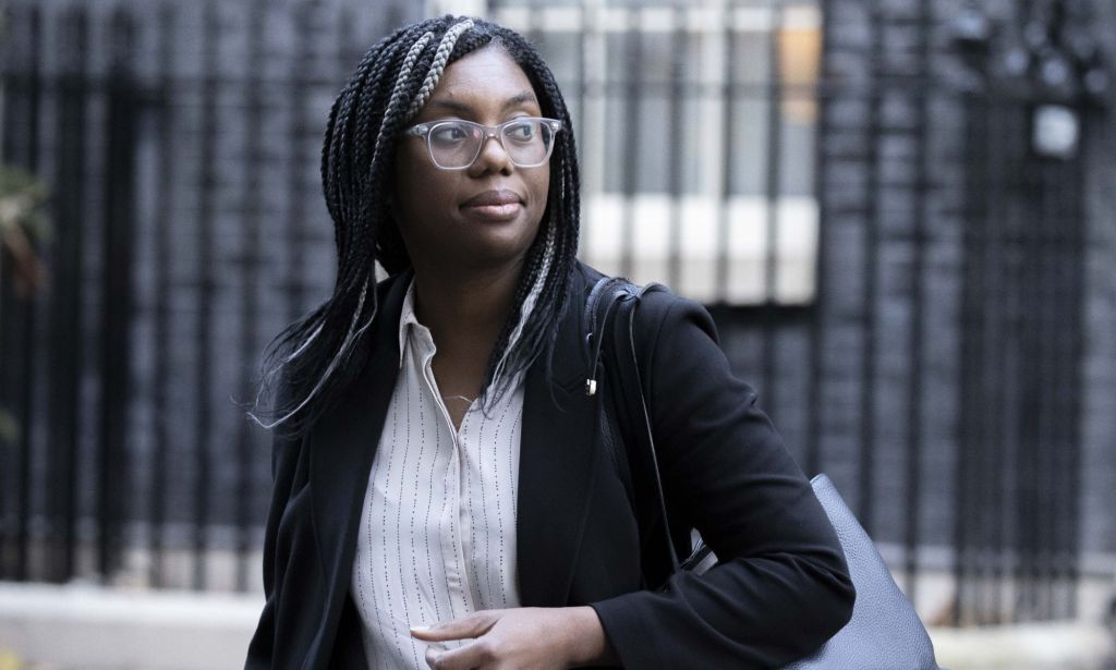 Kemi Badenoch walks across the streets of Number 10, wearing a black blazer.