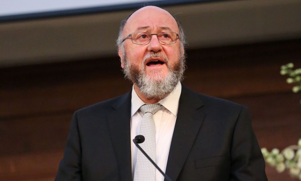 Ephraim Mirvis speaks into a microphone during an address