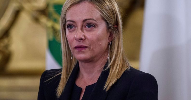 Italy's new prime minister Giorgia Meloni wears a dark outfit as she stares somewhere off camera