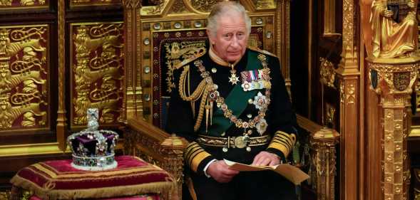 A photo of King Charles III sitting next to St Edward's Crown