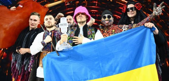 Eurovision Song Contest 2022 winners Kalush Orchestra holding a Ukrainian flag