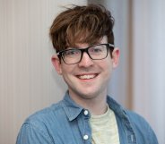 A close-up photo of Galway City councillor Owen Hanley wearing a grey t-shirt and blue shirt wearing glasses and smiling to the camera