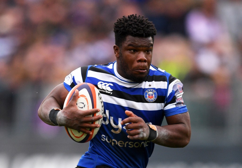 Rugby player Levi Davis runs with a rugby ball in his hands