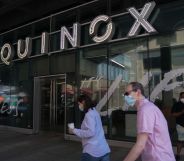 Two people walk past an Equinox gym in New York