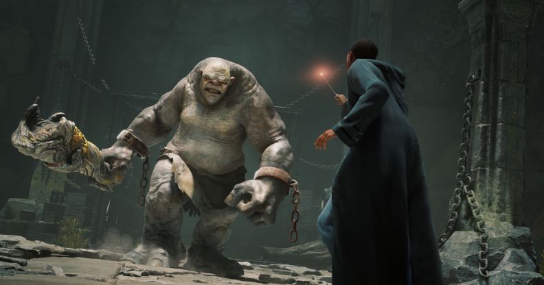 A student at Hogwarts uses a wand against a giant troll.