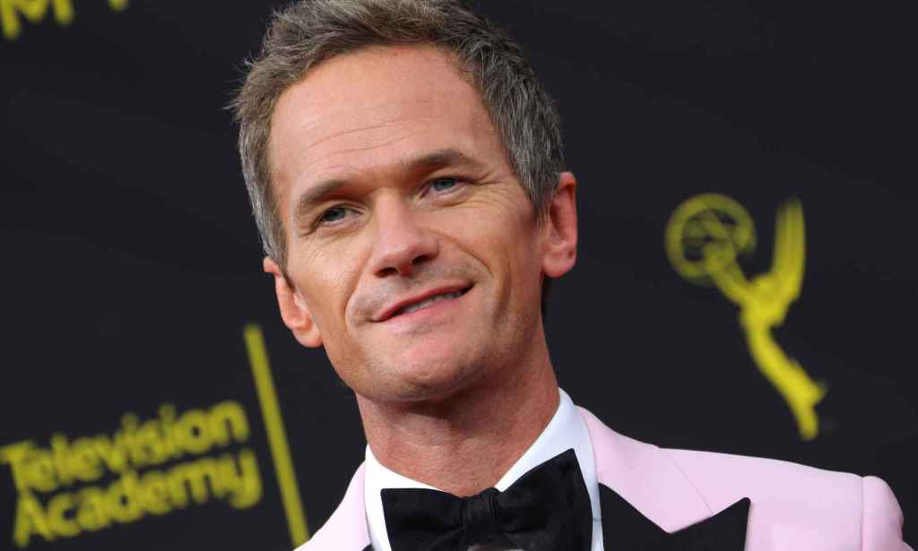 Neil Patrick Harris in a baby pink tuxedo and black bow tie