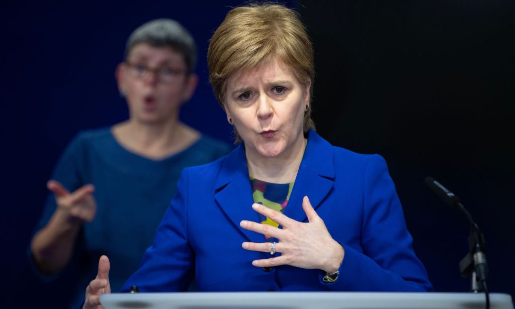 Nicola Sturgeon, in a blue blazer, speaks during an NHS event.