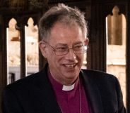 Steven Croft smiles while inside a Church of England church.