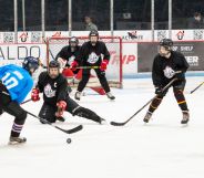 Players for Team Trans play hockey against each other on the ice