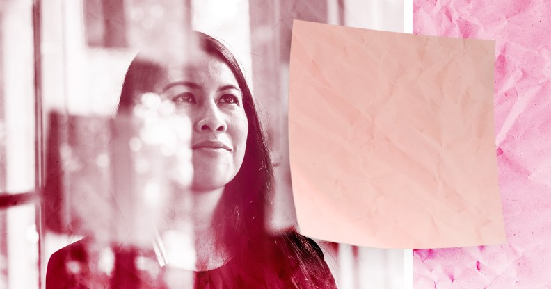 Woman looking at sticky notes at work