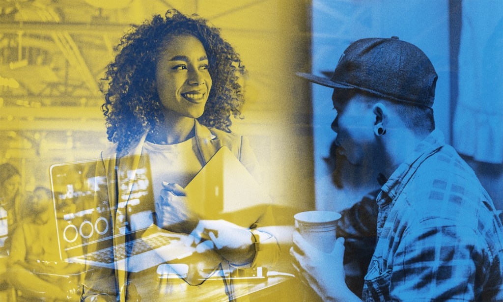 A black woman looks off to the distance holder her laptop while a man works at his computer with a coffee.