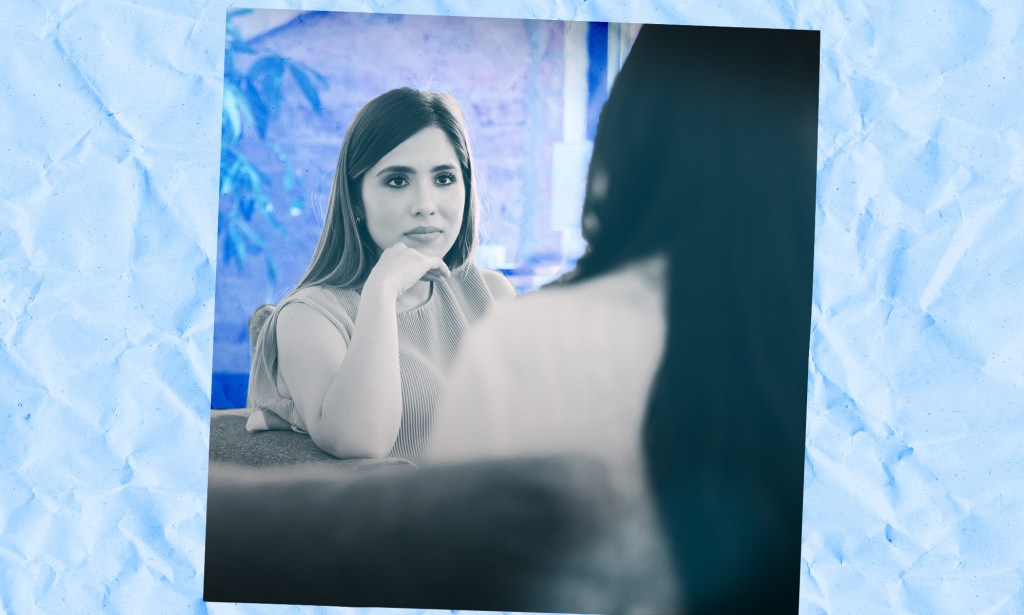 A women is listening intently to a colleague speaking.