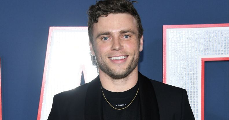 Photo of actor Gus Kenworthy wearing a black suit at the 80 for brady premiere