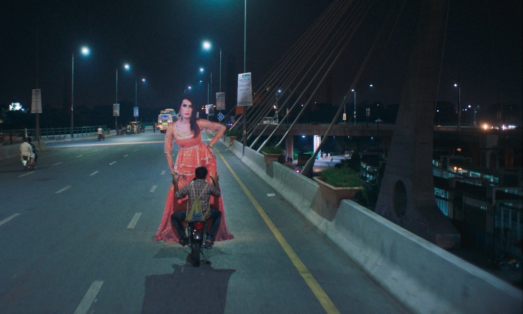 Haider drives a massive cardboard cutout of Biba through the Lahore streets. (Studio Soho)