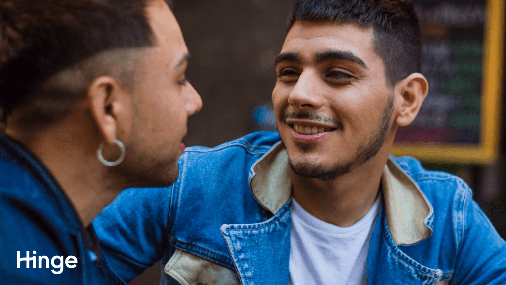 Two men on a date looking at each other