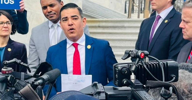 Robert Garcia, surrounded by press, during his speech about aims to expel George Santos.