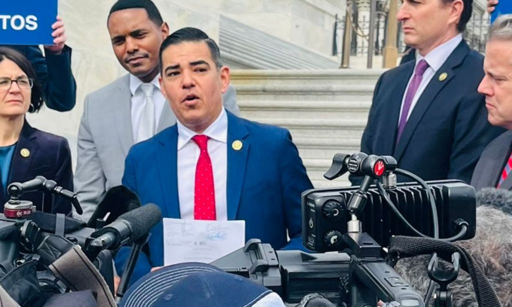 Robert Garcia, surrounded by press, during his speech about aims to expel George Santos.