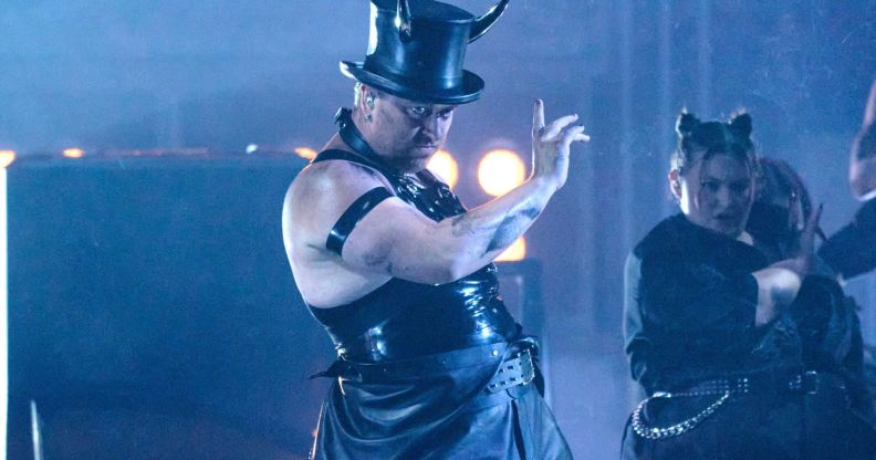 Sam Smith performs at the Brit Awards wearing a latex vest, top hat and devil horns.