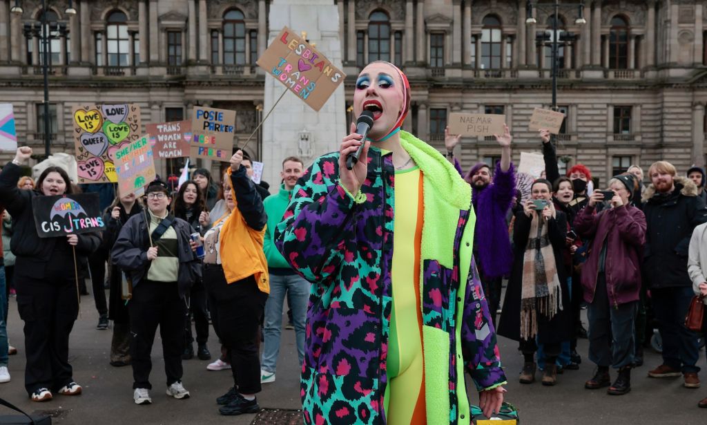 A crowd of LGBTQ+ people and supporters counter-protest against anti-trans activist Posie Parker